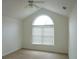 Empty bedroom with a large window and vaulted ceiling at 735 Sunset Ridge Ln, Lawrenceville, GA 30045