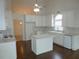 A charming kitchen with white cabinets, stainless steel appliances, an island, and a dining area at 735 Sunset Ridge Ln, Lawrenceville, GA 30045