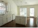 Eat-in kitchen with stainless steel appliances, island, and natural light from sliding glass door at 735 Sunset Ridge Ln, Lawrenceville, GA 30045