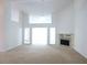 Open-concept living room with cozy fireplace, plush carpeting, and vaulted ceilings at 735 Sunset Ridge Ln, Lawrenceville, GA 30045