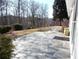 Flagstone patio running along the side of the property, next to mature trees and landscaping at 735 Sunset Ridge Ln, Lawrenceville, GA 30045
