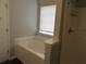Bathtub and shower with white surrounds and chrome fixtures at 4423 Gladewood Run, Union City, GA 30291