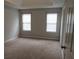 Neutral Primary bedroom with carpet, two windows, and white trim at 4423 Gladewood Run, Union City, GA 30291