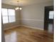 Bright dining room featuring hardwood floors, a modern chandelier, and ample natural light at 4423 Gladewood Run, Union City, GA 30291