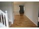 Welcoming hallway with gleaming hardwood floors and staircase, leading to the upper level of the home at 4423 Gladewood Run, Union City, GA 30291