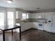Well-lit kitchen featuring white cabinets, a breakfast table, and modern appliances for easy meal preparation at 4423 Gladewood Run, Union City, GA 30291