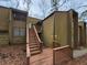 Two-story condo featuring wood siding and an elevated front entry with stairs at 5820 Par Four Ct, Lithonia, GA 30038