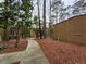 Landscaped exterior walkway with surrounding trees, leading to condo units at 5820 Par Four Ct, Lithonia, GA 30038