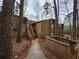 Condo with wood siding, exterior stairs, set in a wooded landscape at 5820 Par Four Ct, Lithonia, GA 30038