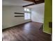 Living room with wood laminate floors, fireplace, and bright lighting at 5820 Par Four Ct, Lithonia, GA 30038