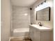 Bathroom featuring modern vanity, updated fixtures, and tiled shower with tub at 127 Holly St, Social Circle, GA 30025