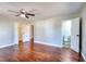 Bedroom with hardwood floors, ceiling fan, two closets, and adjacent bathroom at 127 Holly St, Social Circle, GA 30025
