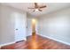 Bedroom featuring hardwood floors, ceiling fan, closet, and bright natural light at 127 Holly St, Social Circle, GA 30025