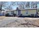 Charming single-story home with a tidy front yard, a metal roof, and a quaint covered entryway at 127 Holly St, Social Circle, GA 30025
