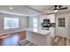 Bright kitchen featuring an island, stainless appliances, white cabinetry, and an adjacent living space at 127 Holly St, Social Circle, GA 30025