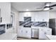 A bright kitchen featuring modern appliances, stylish backsplash, and pristine white cabinets at 127 Holly St, Social Circle, GA 30025