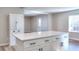 Well-lit kitchen island offering ample storage and counter space with seating and bright light at 127 Holly St, Social Circle, GA 30025
