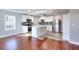 Well-lit kitchen with modern appliances, center island, and hardwood floors at 127 Holly St, Social Circle, GA 30025
