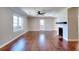 Inviting living room with gleaming hardwood floors, a classic fireplace, and a bright window at 127 Holly St, Social Circle, GA 30025