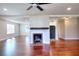 Open-concept living area with fireplace, hardwood floors, and seamless access to kitchen and dining at 127 Holly St, Social Circle, GA 30025