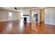Spacious living room boasting wood flooring, fireplace, natural light, and seamless access to the kitchen at 127 Holly St, Social Circle, GA 30025