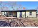 View of the home's rear exterior, showing a small patio and tidy yard on a bright, sunny day at 127 Holly St, Social Circle, GA 30025