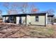 Shows the rear exterior with a small patio and tidy yard under a clear sky; note the well-maintained siding at 127 Holly St, Social Circle, GA 30025