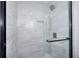 Modern tiled shower stall featuring a glass door, black hardware, and built-in niche at 127 Holly St, Social Circle, GA 30025