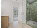Bathroom with tiled shower and glass door and sink with wooden cabinets at 203 Retreat Ln, Canton, GA 30114