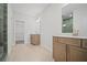 Spacious bathroom featuring a walk-in closet and double sink with wooden cabinets at 203 Retreat Ln, Canton, GA 30114