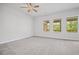 Spacious bedroom featuring soft carpeting and ceiling fan, complimented by natural light at 203 Retreat Ln, Canton, GA 30114