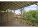 Inviting wooden deck with railing and partial privacy fence, surrounded by lush greenery at 203 Retreat Ln, Canton, GA 30114