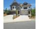 Charming townhome with gray and white facade, two-car garage and well manicured lawn at 203 Retreat Ln, Canton, GA 30114