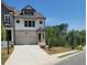 Inviting home with a two-car garage, tidy landscaping, and a welcoming entrance at 203 Retreat Ln, Canton, GA 30114