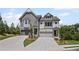 Charming new townhome features a brick and shingle exterior with well-manicured landscaping at 203 Retreat Ln, Canton, GA 30114