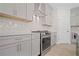 Bright kitchen features modern cabinets, stainless steel appliances, and stylish herringbone backsplash at 203 Retreat Ln, Canton, GA 30114