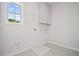 Laundry room with a utility sink, white cabinets and tile floors at 203 Retreat Ln, Canton, GA 30114