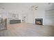 Open concept kitchen and living room features a fireplace and modern lighting at 203 Retreat Ln, Canton, GA 30114