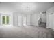 Spacious living room with plush carpeting, recessed lighting and staircase at 203 Retreat Ln, Canton, GA 30114