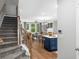 Inviting open-concept living space with hardwood floors, large windows, and modern kitchen island at 203 Retreat Ln, Canton, GA 30114