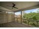 Covered patio with a stained wood deck, ceiling fan, privacy partition, and natural view at 203 Retreat Ln, Canton, GA 30114