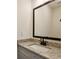 Bathroom boasts granite counters, black fixtures, and large mirror at 310 Mcdonough Se Blvd # 104, Atlanta, GA 30315