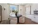 Cozy dining area with a round table, stylish chairs, a large window, and modern wall sconces at 310 Mcdonough Se Blvd # 104, Atlanta, GA 30315