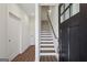 Bright foyer with wood floors leads to a staircase with a wood handrail and white risers at 310 Mcdonough Se Blvd # 104, Atlanta, GA 30315