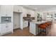 Open kitchen with white cabinetry, stainless appliances, island with seating, and views to the living area at 310 Mcdonough Se Blvd # 104, Atlanta, GA 30315