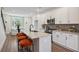 Modern kitchen featuring white cabinets, stainless steel appliances, and a granite island with seating at 310 Mcdonough Se Blvd # 104, Atlanta, GA 30315
