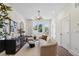 Inviting living room with a modern chandelier, neutral furniture, and plenty of natural light at 310 Mcdonough Se Blvd # 104, Atlanta, GA 30315