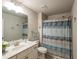 Clean bathroom with a single sink vanity, shower with curtain and decorative nautical accents at 2101 Slick Stone Dr, Snellville, GA 30078