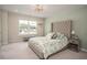 Bright bedroom with a large window, decorative accents and a beautifully dressed queen bed at 2101 Slick Stone Dr, Snellville, GA 30078