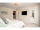 Bedroom with a television on the wall, a mirror on the door, and an ensuite bathroom at 2101 Slick Stone Dr, Snellville, GA 30078